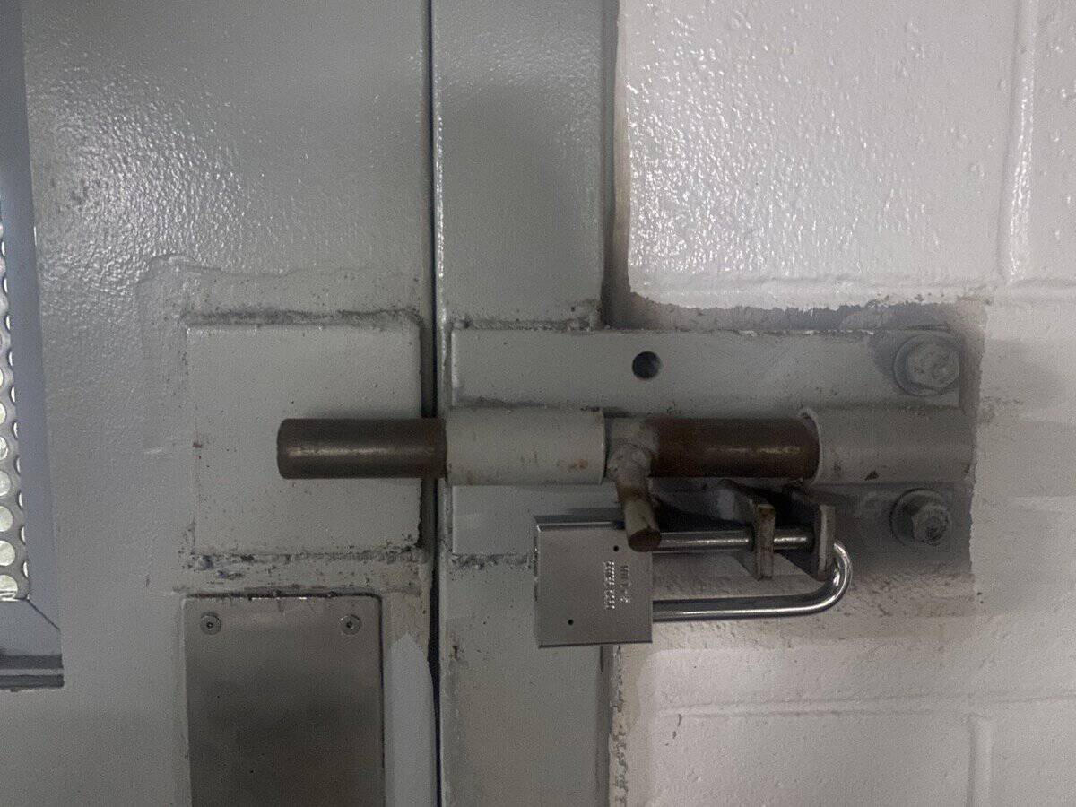 Barrel bolt and padlock on a cell door inside a Georgia state prison, 2022